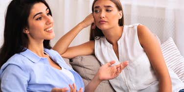annoyed woman staring at friend she doesn't like