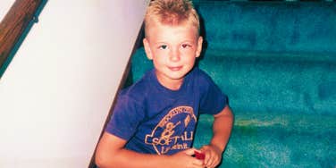 kid growing up in the 1980s sitting alone on the staircase