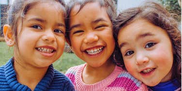 happy trio of kids growing up together