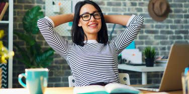 gen z woman working in an office smiling