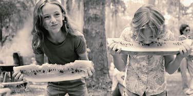 kids eating watermelon and laughing in the 1970s