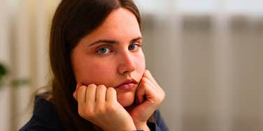serious woman leading a sad life feeling depressed at home alone