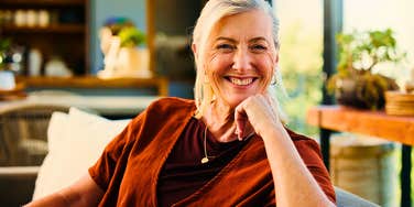 stress free older woman sitting comfortably at home