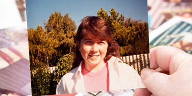 A woman's hand holding an old 1980s photo, illustrating Generation X nostalgia, cultural memory, and the emotional connection between past and present identity.