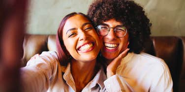 happy couple smiling big for a selfie