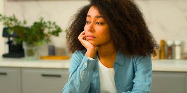 lonely woman sitting by herself at home