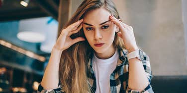 Childish adult woman looks annoyed in restaurant