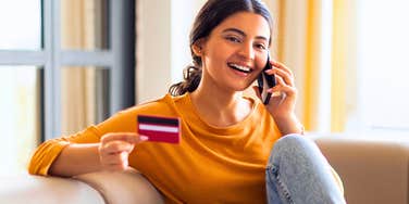 young Gen Z woman making a comfort purchase on her phone