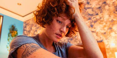 stressed out gen Z woman worried at home