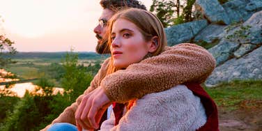 mentally and emotionally complex woman thinking deeply next to her partner