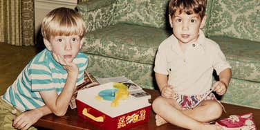 young kids playing old-school game on coffee table
