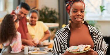 mom holding plate of food defining her role in the family home