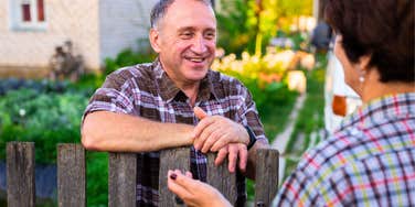 older man talking to woman and being a good neighbor