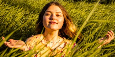 spiritual young woman sitting in the grass