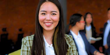 young gen Z worker smiling in the office