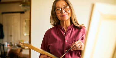 woman raised in the 1960s enjoying hobby of painting