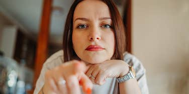 jealous woman pointing at viewer
