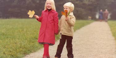 Two kids raised in the late 1970s walk down a grassy path