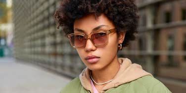 Serious young woman whose low effort parents disappointed her