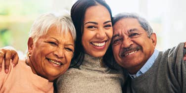 smiling woman with old-school parents looking happy