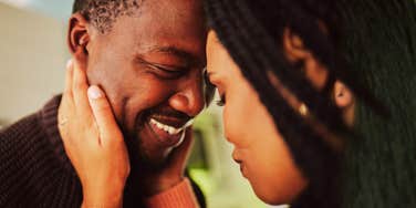 A man making his wife feel deeply loved sharing a peaceful moment of closeness in their home, symbolizing commitment, mutual care, and emotional security.
