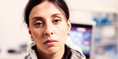 mentally and emotionally tired woman looking into camera 