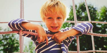young boy on the playground growing up in the 1960s