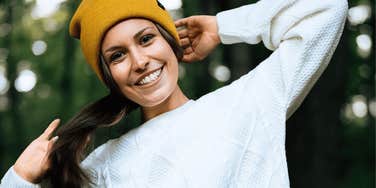 woman who is actually calm on the inside smiling outdoors 