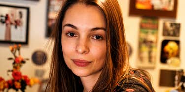 A young woman looking thoughtfully forward with a serene, confident expression, symbolizing emotional intelligence, conflict resolution, and mental resilience.