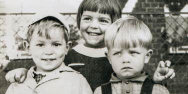 siblings growing up in the 1960s smiling for a photo