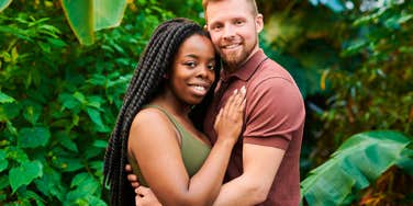 happy couple hugging and posing together outside
