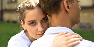 young wife leans on her husband as she loses control of her marriage 