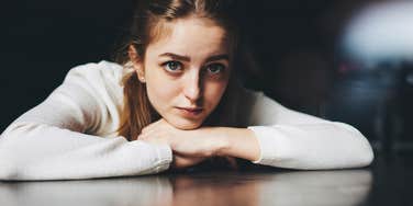 woman with a big heart looking at the camera with soulful eyes