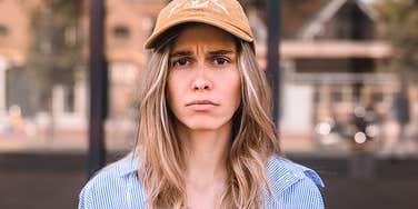 Emotionally weak woman looking pathetic in a hat 
