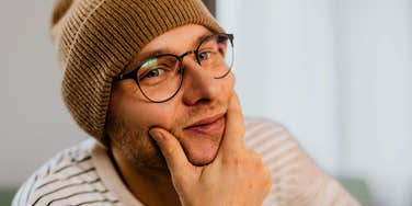 smug man touching his chin not taking accountability
