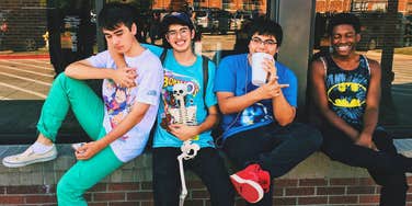 group of teens sitting together outside the mall