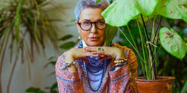 older woman looking serious and defiant among plants