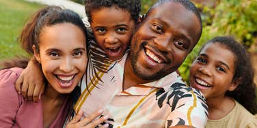 happy man with a big heart taking a selfie with wife and kids