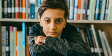 frustrated child sitting in school library