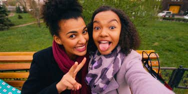 carefree young friends being silly posing for selfie