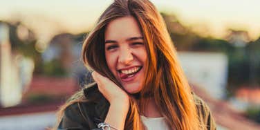 happy woman feeling silly revealing her true personality