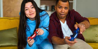 happy couple playing video games together