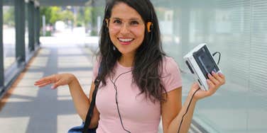 woman holding Walkman revealing her age with the words she uses