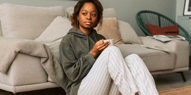 homebody woman relaxing at home after canceling plans
