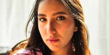 Woman's neutral, distant expression in close-up, hinting at the subtle signs of a fading friendship