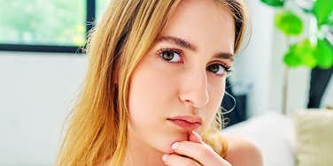 Her fingers rest thoughtfully at her chin, the classic pose of someone about to sound very deep.