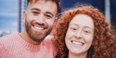 gen z couple smiling warmly together