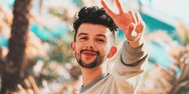 gen Z person holding up a peace sign setting boundaries