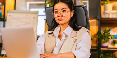 serious young gen Z woman working in the office