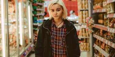 young woman looking impatient at the grocery store